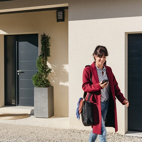 Woman in front if her house